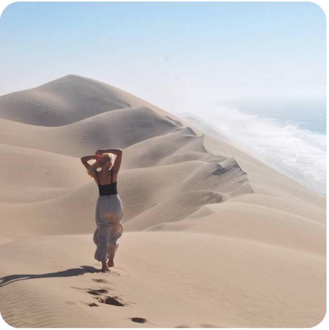 Student posing in the desert on study abroad trip in Namibia